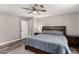 Neutral main bedroom with wood floors, a ceiling fan, and bright, natural light at 846 N 81St St, Mesa, AZ 85207