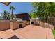 Outdoor kitchen features a stucco grill, a pizza oven, and a blue outbuilding in a beautiful backyard at 846 N 81St St, Mesa, AZ 85207