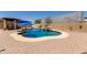 A refreshing swimming pool with a small waterfall feature is surrounded by a brick patio and two blue umbrellas at 846 N 81St St, Mesa, AZ 85207