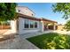 The backyard features a covered patio, lush lawn and block fence for privacy at 919 W Yellowstone Way, Chandler, AZ 85248