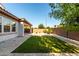 The backyard features a covered patio, lush lawn and block fence for privacy at 919 W Yellowstone Way, Chandler, AZ 85248