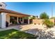 Home's backyard featuring a covered patio, barbecue, and artificial turf area at 919 W Yellowstone Way, Chandler, AZ 85248