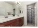 Bathroom with double sinks, vanity and a shower behind a curtain at 919 W Yellowstone Way, Chandler, AZ 85248