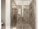 Modern bathroom featuring tile shower with glass door, gray tile walls, and a built in shower niche at 919 W Yellowstone Way, Chandler, AZ 85248