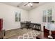 Bedroom featuring a ceiling fan, carpet floors, plantation shutters, and a workspace area at 919 W Yellowstone Way, Chandler, AZ 85248