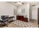 Bedroom featuring a ceiling fan, carpet floors, plantation shutters, wood furniture, and a workspace area at 919 W Yellowstone Way, Chandler, AZ 85248