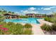 Large community pool with cabana, lounge chairs, and beautiful landscaping at 919 W Yellowstone Way, Chandler, AZ 85248