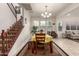 Bright dining room with tile flooring and an elegant chandelier, adjacent to the stairway at 919 W Yellowstone Way, Chandler, AZ 85248