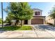 Charming two-story home featuring desert landscaping, a spacious driveway, and a two-car garage at 919 W Yellowstone Way, Chandler, AZ 85248