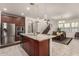 Open-concept kitchen adjacent to dining area with granite center island and stainless steel appliances at 919 W Yellowstone Way, Chandler, AZ 85248
