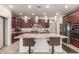 Gourmet kitchen featuring a granite island with seating and updated stainless steel appliances at 919 W Yellowstone Way, Chandler, AZ 85248