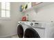 Bright laundry room featuring modern washer and dryer units with white walls at 919 W Yellowstone Way, Chandler, AZ 85248