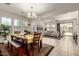 Open-concept living and dining area with tile floors, neutral decor, and sliding glass doors to backyard at 919 W Yellowstone Way, Chandler, AZ 85248