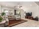Comfortable living room with a large sectional sofa, tile floors, and a sliding glass door to the backyard at 919 W Yellowstone Way, Chandler, AZ 85248