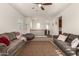 Spacious living room featuring vaulted ceilings, large sofas, ceiling fan, and neutral carpet at 919 W Yellowstone Way, Chandler, AZ 85248