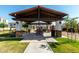 Exterior view of neighborhood ramada featuring picnic table, BBQ, lighting and landscaping at 919 W Yellowstone Way, Chandler, AZ 85248