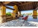Outdoor ramada with fireplace, lounge chairs, bench seating, and lake views at 919 W Yellowstone Way, Chandler, AZ 85248