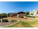 Community playground featuring slides and play area surrounded by lush landscaping at 919 W Yellowstone Way, Chandler, AZ 85248