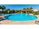 Community pool featuring tanning ledge, tropical landscaping, ramada, and lounge seating at 919 W Yellowstone Way, Chandler, AZ 85248