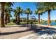 Community swing set overlooking the lake with mature landscaping and clear blue skies at 919 W Yellowstone Way, Chandler, AZ 85248