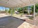 Covered patio overlooking a spacious backyard with mature landscaping and pathways at 920 E Garnet Ave, Mesa, AZ 85204