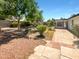 This backyard features desert landscaping, a patio, and a privacy fence at 920 E Garnet Ave, Mesa, AZ 85204