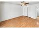 This bedroom features a ceiling fan, natural light, and a closet at 920 E Garnet Ave, Mesa, AZ 85204