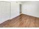 This bedroom features wood floors, white walls, and double door closet for ample storage at 920 E Garnet Ave, Mesa, AZ 85204