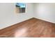 Bedroom featuring wood-look floors, and a bright interior with a large window at 920 E Garnet Ave, Mesa, AZ 85204