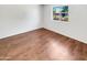 Bedroom featuring wood-look floors, and a bright interior with a large window at 920 E Garnet Ave, Mesa, AZ 85204