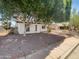 The front of this home features desert landscaping and an awning at 920 E Garnet Ave, Mesa, AZ 85204