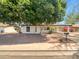 The front of this home features trees, shrubbery and an awning at 920 E Garnet Ave, Mesa, AZ 85204