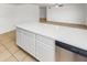 This kitchen island has white cabinets, white countertops, and stainless steel dishwasher at 920 E Garnet Ave, Mesa, AZ 85204
