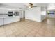Eat-in kitchen features white cabinetry, stainless steel appliances, and an open floor plan at 920 E Garnet Ave, Mesa, AZ 85204