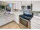 This kitchen is equipped with stainless steel appliances, tile backsplash, and white countertops at 920 E Garnet Ave, Mesa, AZ 85204