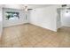 A bright living room featuring tile flooring, a ceiling fan, and window at 920 E Garnet Ave, Mesa, AZ 85204