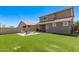 Backyard showcasing a patio with seating area, artificial turf, and desert landscaping at 932 W Capulin Trl, San Tan Valley, AZ 85140