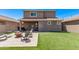 Home's backyard includes seating area, fire pit, turf, and desert landscaping at 932 W Capulin Trl, San Tan Valley, AZ 85140