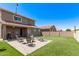 Backyard features a patio, outdoor seating area, artificial turf, and string lights at 932 W Capulin Trl, San Tan Valley, AZ 85140