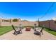 Backyard patio with a fire pit and chairs, perfect for entertaining guests at 932 W Capulin Trl, San Tan Valley, AZ 85140