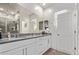 Elegant bathroom with a large mirror, double sinks, granite countertops, and a glass-enclosed shower at 932 W Capulin Trl, San Tan Valley, AZ 85140