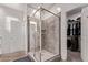 Stylish bathroom with a glass-enclosed shower and access to a walk-in closet at 932 W Capulin Trl, San Tan Valley, AZ 85140