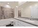 Stylish bathroom features dual sinks, granite counters, tile surround and shower at 932 W Capulin Trl, San Tan Valley, AZ 85140