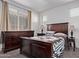 Comfortable bedroom with carpet floors, a large window providing natural light, and a matching set of wooden furniture at 932 W Capulin Trl, San Tan Valley, AZ 85140