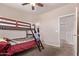 Comfortable bedroom with bunkbeds, carpet flooring, and ensuite closet/bathroom at 932 W Capulin Trl, San Tan Valley, AZ 85140