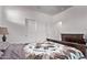 Spacious bedroom with a bed decorated with a patterned quilt and a set of wooden furniture providing storage space at 932 W Capulin Trl, San Tan Valley, AZ 85140