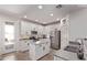 Bright kitchen featuring white cabinets, an island, stainless steel appliances, and granite countertops at 932 W Capulin Trl, San Tan Valley, AZ 85140
