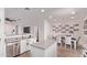 Modern kitchen and dining area with stainless steel appliances, white cabinetry, and granite countertops at 932 W Capulin Trl, San Tan Valley, AZ 85140
