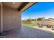 Covered patio features pavers, string lights, artificial turf and a seating area at 932 W Capulin Trl, San Tan Valley, AZ 85140