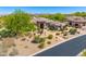 Desert home with lush landscaping, paver walkway, and desert-style plants at 9534 E Monument Dr, Scottsdale, AZ 85262